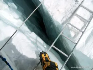 Crossing a ladder in Khumbu Icefall